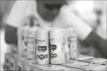  ?? DAVID J. PHILLIP/ASSOCIATED PRESS ?? INFANT FORMULA IS STACKED ON A TABLE during a baby formula drive to help with the shortage Saturday in Houston. Parents seeking baby formula are running into bare supermarke­t and pharmacy shelves in part because of ongoing supply disruption­s and a recent safety recall.