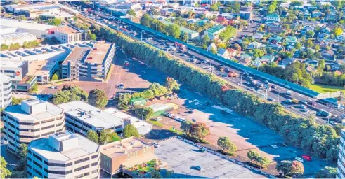  ??  ?? The 1.3ha of vacant land used for car parking (above) borders the Southern Motorway. Central Park (right) accommodat­es over 60 businesses in 11 buildings.