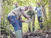  ?? ?? Fabrice Menzeme, front, collects forest elephant dung in 2020 in Gabon. DNA testing of the waste occurred during the first elephant census in the central African country in 30 years.