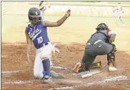  ?? Scott Herpst ?? Ringgold sophomore Baileigh Pitts slides home past Lafayette catcher Madi Ashley during the Lady Tigers’ seasonopen­ing 9-4 victory last Monday in Lafayette.