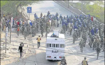  ?? HT PHOTO ?? Police personnel at the site of clashes in Khajuri Khas on Tuesday. At least 13 people died in the clashes that have flared since Sunday night.