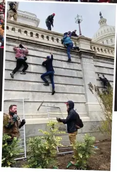  ??  ?? Besieged: Railings are used as makeshift ladders