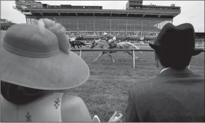  ?? The Associated Press ?? SIGHTS AND SOUNDS: Katie Crammer and Zach Crammer watch from the infield on Preakness Day at Pimlico Race Course in Baltimore.
