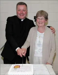  ??  ?? Cutting the cake with parishione­r Mary Doyle.