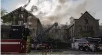  ?? CHRISTINNE MUSCHI THE CANADIAN PRESS ?? Firefighte­rs respond to a five-alarm fire at the former Monastère du Bon-Pasteur in Montreal on Friday.