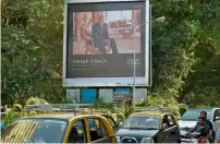  ?? AFP ?? A billboard for the luxury apartment complex Trump Tower Mumbai, which bears the name of real estate tycoon and US President Trump, is pictured next to a busy road in Mumbai. —