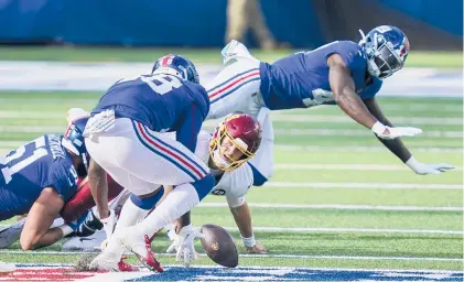  ?? JOHN MINCHILLO/AP ?? Washington quarterbac­k Kyle Allen fumbles and watches Giants linebacker Tae Crowder (back to camera) recover it. Crowder returned it for a touchdown Sunday in East Rutherford, N.J.