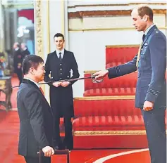  ??  ?? Poh being dubbed by Prince William in a knighting ceremony.