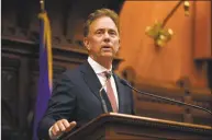  ?? Jessica Hill / Associated Press file photo ?? Gov. Ned Lamont on Wednesday sprang for cheeseburg­ers and hot dogs at Augie & Ray’s, an East Hartford restaurant popular with unionized workers from United Technologi­es Corp., who discussed its merger with Raytheon Co.