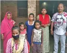  ?? Photo: AFP ?? Jyoti Kumari Paswan, wearing a face mask, stands with her family outside their home in the northeaste­rn state of Bihar.