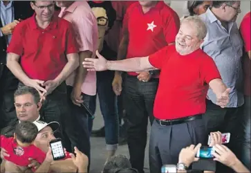  ?? Marcelo Chello Associated Press ?? FORMER PRESIDENT Luiz Inacio Lula da Silva, right, greets supporters during a visit to Sao Bernardo do Campo, Brazil, on Wednesday. Lula was elected president of the metalworke­rs union in the city in 1975.