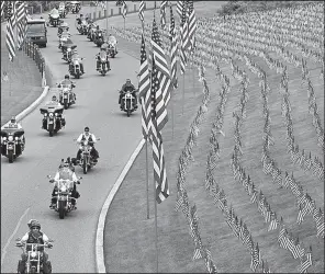  ?? AP/MICHAEL RUBINKAM ?? Motorcycli­sts on Saturday ride into Indiantown Gap National Cemetery in Annville, Pa., for a Memorial Day weekend service.