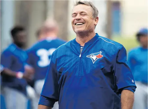  ?? NATHAN DENETTE / THE CANADIAN PRESS ?? Toronto Blue Jays manager John Gibbons has a laugh at spring training in Dunedin. Gibbons is holding off on playing his veterans early in the Grapefruit League in order to give younger players a look-see.
