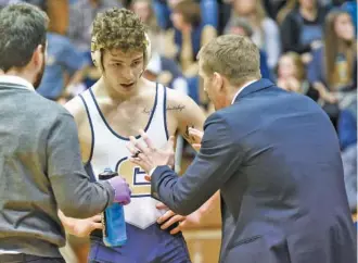  ?? STAFF PHOTO BY TIM BARBER ?? UTC wrestling coach Kyle Ruschell encourages Ryan Resnick during a referee review of his questionab­le takedown of Campbell University’s Benjamin Barton just before his 7-6 decision in the 157-pound weight class Sunday inside Maclellan Gym.