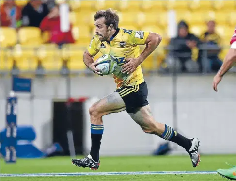  ?? Photo: PHOTOSPORT ?? Runaway leader: Hurricanes centre Conrad Smith streaks away during his side’s 36-12 Super Rugby win over the Melbourne Rebels at Westpac Stadium.