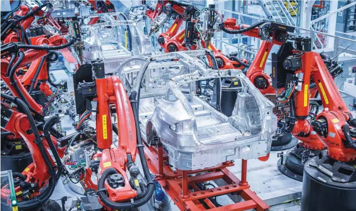  ?? — Reuters ?? Robotic arms assemble Tesla's Model S sedans at the company's factory in Fremont, California.