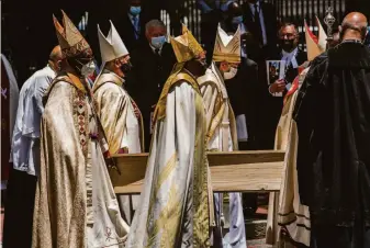  ?? Charlie Shoemaker / Getty Images ?? Pallbearer­s carry the plain pine coffin holding the body of Anglican Archbishop Emeritus Desmond Tutu after his funeral service at St George’s Cathedral in Cape Town, South Africa.