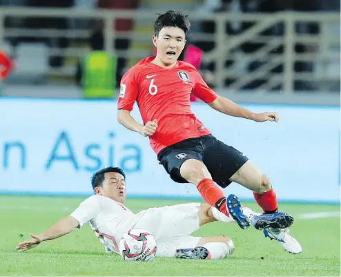  ?? —AP ?? The Whitecaps have signed South Korean midfielder Hwang In-beom, in red, seen in action against China earlier this month at the 2019 AFC Asian Cup. Hwang was named one of the 10 best young stars to watch at the event.