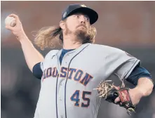  ?? DAVID J. PHILLIP/AP ?? Astros relief pitcher Ryne Stanek throws during the seventh inning of Game 3 of the World Series on Friday in Atlanta.