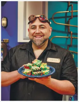  ??  ?? Goldman, left, holds a finished creation on the show: Duff’s Magical Rainbow White Chocolate Brownies.