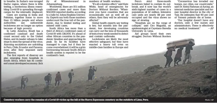  ?? Photo / AP ?? Cemetery workers carry the remains of a Covid-19 victim up the hill at the Nueva Esperanza cemetery on the outskirts of Lima, Peru.