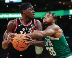  ?? AP Photo/Michael Dwyer ?? ■ Boston Celtics’ Marcus Smart (36) defends against Toronto Raptors’ Pascal Siakam during the second half Friday in Boston.