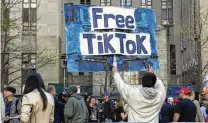  ?? TED SHAFFREY / AP ?? A man carries a “Free TikTok” sign in front of the courthouse where the hush money trial of Donald Trump was taking place, Monday in New York. The House passed legislatio­n Saturday to ban TikTok in the U.S. if its China-based owner doesn’t sell its stake.