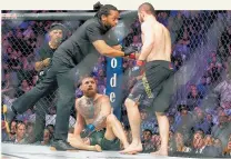  ?? Picture / Getty Images ?? Nurmagomed­ov is held by the ref during his fight.