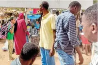  ?? ?? People fleeing violence wait for their buses before departure from Al Sittin road in the south of Khartoum on Tuesday. — afp