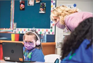  ??  ?? First lady Jill Biden watches a student work as she tours Benjamin Franklin Elementary School in Meriden on Wednesday.