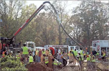  ?? Spencer Lahr / RN-T ?? A Rome Public Works truck is used to suck up dirt from a trench that caved in on a Floyd County Water Department worker.