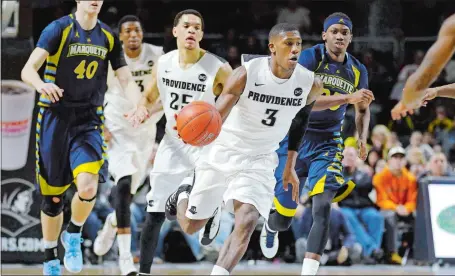  ??  ?? Providence guard Kris Dunn (3) dribbles the ball up court after a turnover by Marquette during a Big East game on March 1. The ex-New London High School All-American recently took part in an invitation-only elite basketball camp in California, where he...