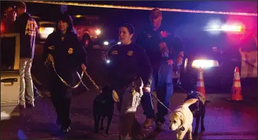  ??  ?? Police dogs and their handlers deploy at the scene of an explosion in southwest Austin on Sunday. Injuries were reported in the explosion, this one coming after three package bombs detonated earlier in the month