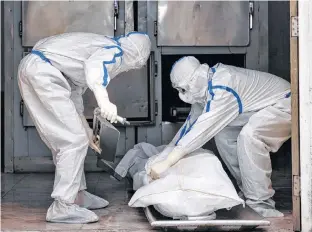  ?? REUTERS ?? Mortuary workers prepare to transport the body of a person who died from COVID-19 at Max Smart Super Speciality Hospital in New Delhi, India on Thursday.