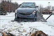  ?? C.B. SCHMELTER/AP ?? A car is loaded onto a wrecker after it crashed in Jackson, Tenn., one of the many fender benders in Friday’s storm.