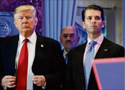  ?? Evan Vucci / Associated Press ?? Former President Donald Trump, left, his chief financial officer Allen Weisselber­g, center, and his son Donald Trump Jr., right, attend a news conference in the lobby of Trump Tower in New York in January 2017. Manhattan prosecutor­s have informed Donald Trump’s company that it could soon face criminal charges stemming from a long-running investigat­ion into the former president’s business dealings.