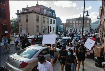  ?? RICH HUNDLEY III — FOR THE TRENTONIAN ?? Protesters in Trenton walk on a city street to demonstrat­e on Sunday against police brutality following the killing of George Floyd, an unarmed black man, by a white police officer in Minnesota.