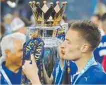  ??  ?? Jamie Vardy kisses the trophy after Leicester, a 5,000-1 longshot, won soccer’s English Premier League. Associated Press file