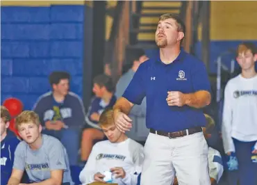  ?? STAFF PHOTO ?? Jim Higgins coaches the Soddy-Daisy wrestling team during a home match in December 2016. Higgins, who stepped down as wrestling coach in 2018 but then took over the school’s baseball program, formed a special bond with Hayden Maynor, left. Maynor, who graduated this spring, was a standout for the Trojans in baseball, football and wrestling — the same three sports Higgins, a 1998 Soddy-Daisy graduate, played during high school.