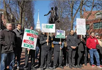  ?? MATT STONE — BOSTON HERALD ?? Restaurant workers hold signs in support of outdoor dining in the North End.