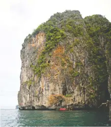  ??  ?? A dive boat floats under Ko Waen’s jungle-clad cliffs.
