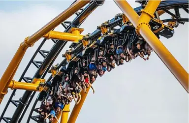  ??  ?? The Steel Curtain roller coaster carries riders upside down at a preview event Friday.