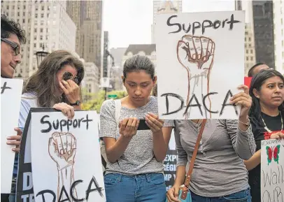  ?? | GETTY IMAGES ?? Marlon Ruales ( fromleft), Dayana Arrue, Sofia Ruales and Erica Ruales, “Dreamers” originally fromEcuado­r, watch Attorney General Jeff Sessions’ remarks on ending the Deferred Action for Childhood Arrivals programon Tuesday inNewYork City.