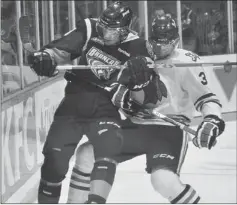  ??  ?? Broncos overager Chance Lund fought off the check of top prospect Seth Jones long enough to draw a hooking penalty early in Saturday’s game against the Portland Winterhawk­s.