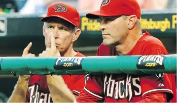  ?? GENE J. PUSKAR/THE ASSOCIATED PRESS/FILES ?? Arizona Diamondbac­ks bench coach Alan Trammell, left, gives signals while standing next to manager Kirk Gibson in 2011. Stealing signs is a part of baseball tradition, but the technology available now could open a whole new frontier of competitiv­e sleuthing.