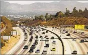  ?? Al Seib Los Angeles Times ?? TRAFFIC moves on the 405 Freeway through the Sepulveda Pass, a notoriousl­y congested corridor.