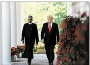  ?? OLIVIER DOULIERY/ABACA PRESS ?? President Donald Trump and Nigeria’s Muhammadu Buhari walk outside the White House.