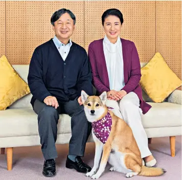  ??  ?? Crown Princess Masako and her husband, Crown Prince Naruhito, with their pet dog, Yuri, at their official residence, Togu Palace