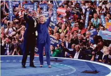  ?? AP ?? Obama and presidenti­al nominee Clinton waves to delegates at the conclusion of the US president’s speech at the Democratic National Convention in Philadelph­ia.