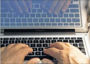  ?? CP PHOTO ?? Hands type on a computer keyboard in Los Angeles in 2013. The death of the password could be upon us. A new security standard recently endorsed by the World Wide Web Consortium has experts excited about the prospect of making logins “unphishabl­e” and...